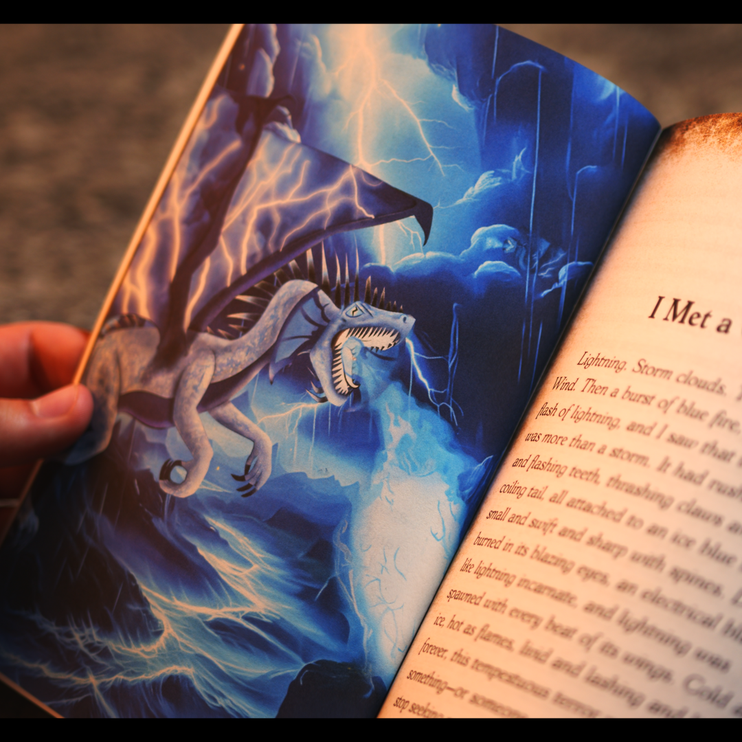 Open book with a dragon illustration on one page and text on the other, held by a person.